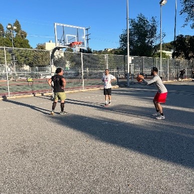 A group of men playing basketball

Description automatically generated