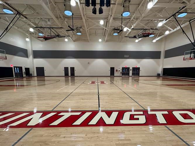 A gym with a red and white sign

Description automatically generated
