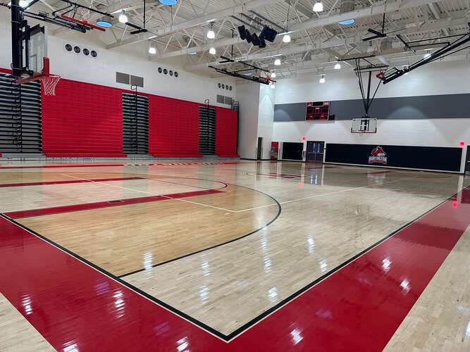 A gym with a basketball court

Description automatically generated