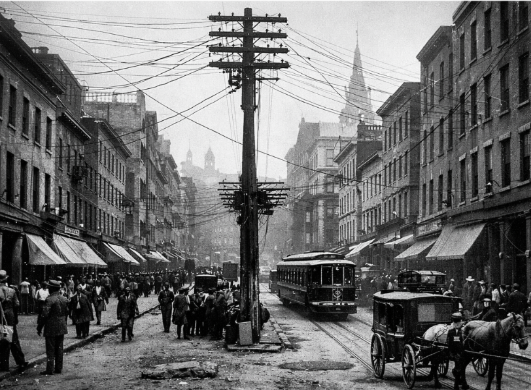 A street with a trolley and people

AI-generated content may be incorrect.