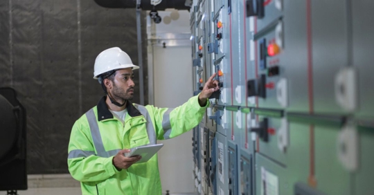 technician looking at industrial control system