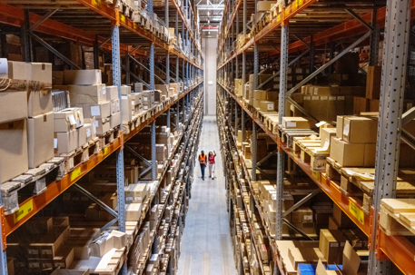 two people walking in a warehouse