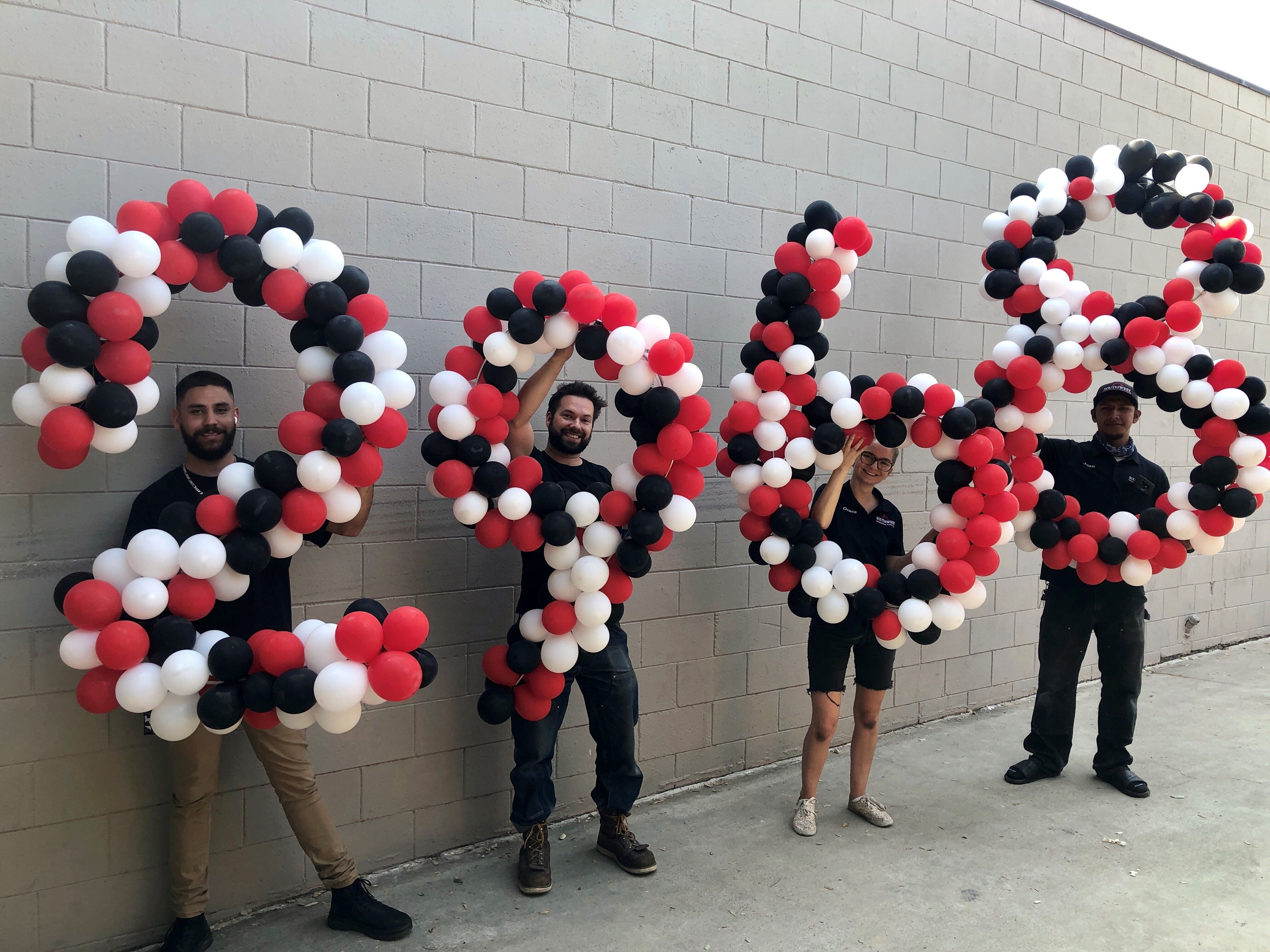 Southwest Electric holding balloons and company event
