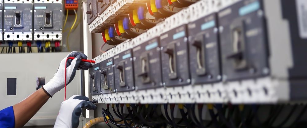 Commercial electrician managing power distribution system
